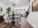 Open concept dining area with modern lighting, wood floors, and natural light at 5516 Swaling St, Charlotte, NC 28217