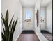 Bright entryway with wood-look floors, decorative mirror and glass front door at 5516 Swaling St, Charlotte, NC 28217