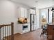 Bright kitchen area with stainless steel appliances and white cabinetry on wood-look floors at 5516 Swaling St, Charlotte, NC 28217