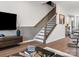 Bright living room with hardwood floors, modern décor, and staircase access at 5516 Swaling St, Charlotte, NC 28217