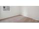 A bedroom that has carpeted floors, a window, and plain white walls at 562 Mountain View Dr, Monroe, NC 28110