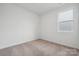 A bedroom that has carpeted floors, a double window, and plain white walls at 562 Mountain View Dr, Monroe, NC 28110