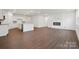 An open concept kitchen flows to the living area with modern fireplace, hardwood floors, and natural light at 562 Mountain View Dr, Monroe, NC 28110