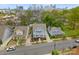 Aerial view of a blue two-story home with landscaped front yard and city skyline in the background at 612 Baldwin Ave, Charlotte, NC 28204