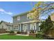 Backyard featuring artificial grass, a stone patio, fire pit, and grill with outdoor seating at 612 Baldwin Ave, Charlotte, NC 28204