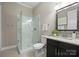 Modern bathroom with a glass-enclosed shower, granite vanity, and updated fixtures at 612 Baldwin Ave, Charlotte, NC 28204