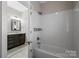 Bright bathroom featuring a shower-tub combo with sleek tile and modern fixtures at 612 Baldwin Ave, Charlotte, NC 28204