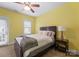 Comfortable bedroom featuring yellow walls, natural light, and a cozy sleeping space at 612 Baldwin Ave, Charlotte, NC 28204