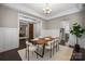 Elegant dining space with a view of a living area and a modern sliding barn door at 612 Baldwin Ave, Charlotte, NC 28204