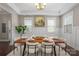 Formal dining room with a large wooden table, stylish chairs, and wainscoting at 612 Baldwin Ave, Charlotte, NC 28204