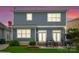 Two-story home featuring an outdoor patio, grill, fire pit, manicured lawn, and backyard at 612 Baldwin Ave, Charlotte, NC 28204