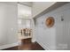 Foyer with hardwood floors, wainscoting, and a view into the dining room at 612 Baldwin Ave, Charlotte, NC 28204