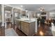 Open concept kitchen with stainless steel appliances, granite countertops, and an island sink at 612 Baldwin Ave, Charlotte, NC 28204