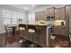 Eat-in kitchen with granite countertops, bar seating, stainless appliances, and hardwood floors at 612 Baldwin Ave, Charlotte, NC 28204