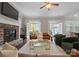 Cozy living room featuring a stone fireplace, hardwood floors, and access to the outdoor area at 612 Baldwin Ave, Charlotte, NC 28204
