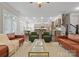 Inviting living room featuring hardwood floors, tan leather sofas, and an open flow to the kitchen at 612 Baldwin Ave, Charlotte, NC 28204