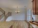 Dining room boasting a chandelier, staircase, and wood-look flooring with natural light at 668 Sixth Baxter Xing, Fort Mill, SC 29708