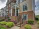 Brick and siding townhome featuring an inviting entrance, landscaped yard, and classic architectural details at 668 Sixth Baxter Xing, Fort Mill, SC 29708