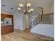 Open concept living room with an island, chandelier, staircase, and stainless steel refrigerator at 668 Sixth Baxter Xing, Fort Mill, SC 29708