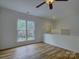 Bright loft area with wood floors, neutral walls, a window, and a view of the stairs at 668 Sixth Baxter Xing, Fort Mill, SC 29708