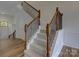 Staircase with carpeted steps and decorative wrought iron spindles at 668 Sixth Baxter Xing, Fort Mill, SC 29708