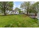 Large, well-maintained backyard with lush grass, mature trees, and a rear view of the home at 745 6Th Sw Ave, Hickory, NC 28602