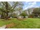Spacious backyard featuring mature trees and multiple sheds for ample storage at 745 6Th Sw Ave, Hickory, NC 28602