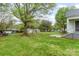 Expansive backyard with lush green grass, mature trees, and multiple storage buildings at 745 6Th Sw Ave, Hickory, NC 28602