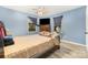 Cozy bedroom with blue walls, a ceiling fan, windows with curtains, and a comfortable bed at 745 6Th Sw Ave, Hickory, NC 28602