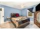 Comfortable bedroom with blue walls, ceiling fan, wood floor and view of the window at 745 6Th Sw Ave, Hickory, NC 28602