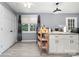 Kitchen featuring hardwood floors, white cabinets, granite counters, an island, and modern appliances at 745 6Th Sw Ave, Hickory, NC 28602