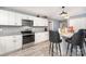 Well-lit kitchen with white cabinets, stainless steel appliances, and granite countertops at 745 6Th Sw Ave, Hickory, NC 28602