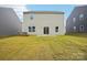 Back exterior view with sliding glass door and ample backyard space perfect for outdoor activities and enjoyment at 8059 Plymouth Dr, Sherrills Ford, NC 28673