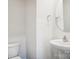 Bathroom featuring a modern sink, round mirror, and toilet against a clean, white backdrop at 8059 Plymouth Dr, Sherrills Ford, NC 28673