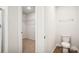 This bathroom offers a toilet and a closet featuring ample shelving and lots of room for storage at 8059 Plymouth Dr, Sherrills Ford, NC 28673