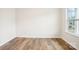 Bedroom with luxury vinyl plank flooring, white walls, and a large window at 8059 Plymouth Dr, Sherrills Ford, NC 28673