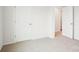 Carpeted bedroom showcasing a clean and bright interior, with doors leading to other rooms at 8059 Plymouth Dr, Sherrills Ford, NC 28673