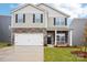 Charming two-story home with a two-car garage, stone accents, and a well-manicured lawn at 8059 Plymouth Dr, Sherrills Ford, NC 28673