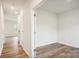 Hallway leading to a room with luxury vinyl plank flooring and white walls at 8059 Plymouth Dr, Sherrills Ford, NC 28673