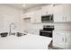 Bright kitchen with white cabinets, modern stainless steel appliances, and a subway tile backsplash at 8059 Plymouth Dr, Sherrills Ford, NC 28673