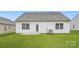 Well-maintained backyard featuring a manicured lawn, a back door, and a concrete patio at 8432 Norman Forest Rd, Lancaster, SC 29720