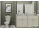 Neutral bathroom with double sink vanity, framed mirror, and accent wall color at 8432 Norman Forest Rd, Lancaster, SC 29720
