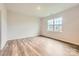 Bright, empty bedroom with wood-look floors and a large window providing natural light at 8432 Norman Forest Rd, Lancaster, SC 29720
