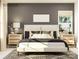 Contemporary bedroom features a gray accent wall, neutral bedding, and decorative lamps at 8432 Norman Forest Rd, Lancaster, SC 29720