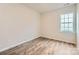 Cozy bedroom featuring wood-look floors, a large window and neutral walls at 8432 Norman Forest Rd, Lancaster, SC 29720
