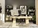 Comfortable home office with a modern desk, ergonomic chair, and decorative shelving at 8432 Norman Forest Rd, Lancaster, SC 29720