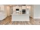 Modern kitchen with stainless steel appliances, white cabinets, subway tile backsplash, and a large island at 8432 Norman Forest Rd, Lancaster, SC 29720