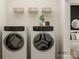 Bright laundry room featuring Electrolux washer/dryer, overhead shelf, and modern finishes at 8432 Norman Forest Rd, Lancaster, SC 29720