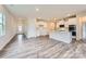 Spacious living area with an open floor plan, featuring a kitchen, natural light, and stylish wood flooring at 8432 Norman Forest Rd, Lancaster, SC 29720