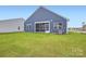 View of blue house exterior and screened porch with large grassy backyard at 8442 Norman Forest Rd, Lancaster, SC 29720